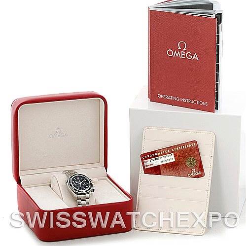 The image shows an Omega Planet Ocean 22230385001001 Stainless Steel Black Dial 22230385001001 Stainless Steel Black Dial watch in a red presentation box, with its operating instructions and warranty card displayed.