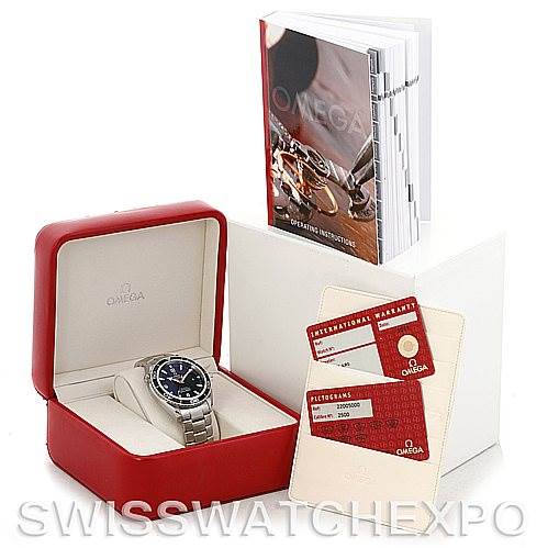 The image shows an Omega Planet Ocean 2200.50.00 Men's Stainless Steel Black Dial 2200.50.00 Men's Stainless Steel Black Dial watch in a red box, with an instruction manual and warranty cards displayed behind it.