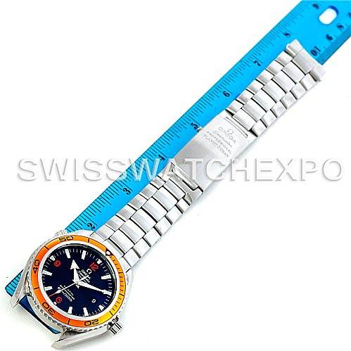 The Omega Planet Ocean 2208.50.00 Men
s Stainless Steel Black Dial 2208.50.00 Men
s Stainless Steel Black Dial watch is shown at a top-down angle, along with its full bracelet and a blue measuring ruler.