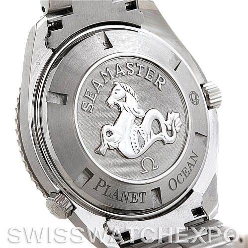 The image shows the case back of the Omega Seamaster Planet Ocean watch, featuring its emblem and engravings.
