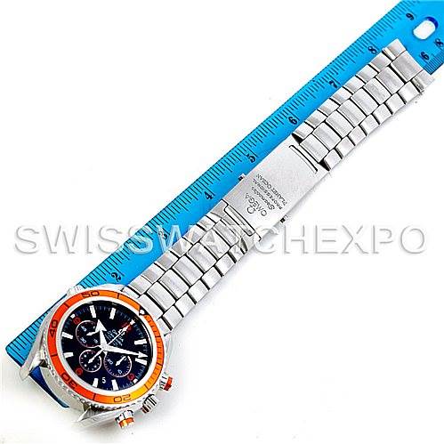 The image shows an Omega Planet Ocean 2218.50.00 Men's Stainless Steel Black Dial 2218.50.00 Men's Stainless Steel Black Dial watch laid flat with a blue ruler for scale, highlighting the face and bracelet.