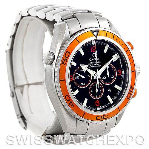 The image shows a side angle of the Omega Planet Ocean 2218.50.00 Men's Stainless Steel Black Dial 2218.50.00 Men's Stainless Steel Black Dial watch, highlighting its orange bezel, dial, and stainless steel bracelet.