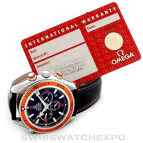 The image shows an Omega Planet Ocean 2918.50.82 Men's Stainless Steel Black Dial 2918.50.82 Men's Stainless Steel Black Dial watch at an angle displaying its face and bezel, alongside an International Warranty card.