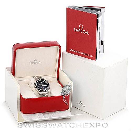 The image shows an Omega Planet Ocean 2200.50.00 Men's Stainless Steel Black Dial 2200.50.00 Men's Stainless Steel Black Dial watch in its box, alongside operating instructions and additional packaging.