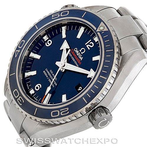 The image shows an Omega Planet Ocean 232.90.46.21.03.001 Men's Titanium Blue Dial 232.90.46.21.03.001 Men's Titanium Blue Dial watch from an angled view highlighting the face, bezel, crown, and part of the bracelet.