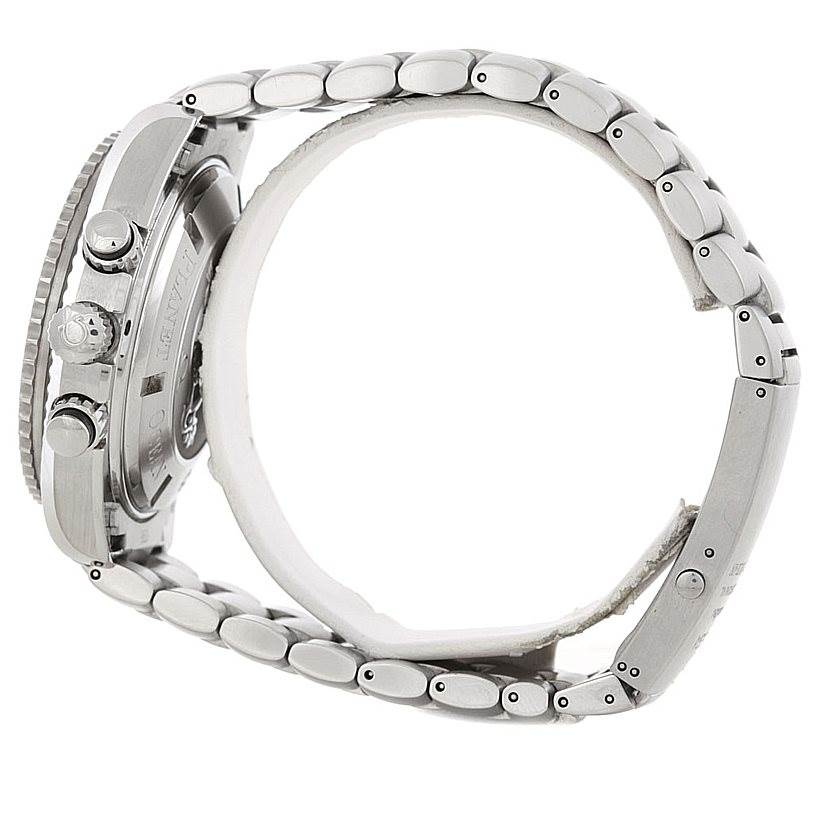 The image shows a side view of the Omega Planet Ocean 2210.50.00 Men's Stainless Steel Black Dial 2210.50.00 Men's Stainless Steel Black Dial watch, highlighting its crown, pushers, and stainless steel bracelet.