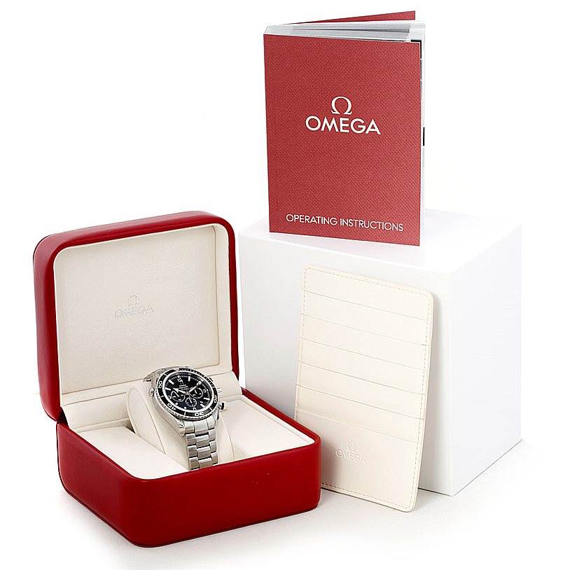 The Omega Planet Ocean 2210.50.00 Men's Stainless Steel Black Dial 2210.50.00 Men's Stainless Steel Black Dial watch is shown in its box with an operating instructions booklet and a cardholder.