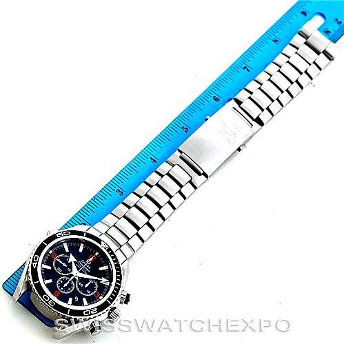 The image shows an overhead view of the Omega Planet Ocean 2210.51.00 Men
s Stainless Steel Black Dial 2210.51.00 Men
s Stainless Steel Black Dial watch, displaying the full bracelet and face alongside a ruler.