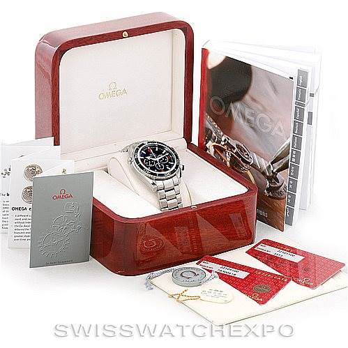 The image shows an Omega Planet Ocean 2210.51.00 Men
s Stainless Steel Black Dial 2210.51.00 Men
s Stainless Steel Black Dial watch in its box with various accessories, including manuals, warranty cards, and a tag.