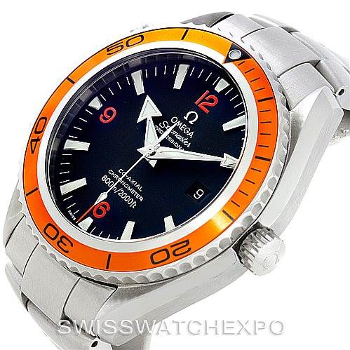 The image shows the Omega Planet Ocean 2208.50.00 Men
s Stainless Steel Black Dial 2208.50.00 Men
s Stainless Steel Black Dial watch from an angled side view, highlighting its orange bezel, black dial, and metal bracelet.
