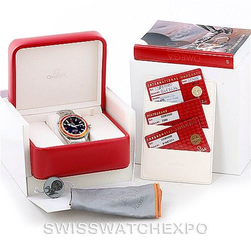 This image showcases an Omega Planet Ocean 2208.50.00 Men
s Stainless Steel Black Dial 2208.50.00 Men
s Stainless Steel Black Dial watch in its open red box, along with warranty cards, a manual, and protective storage accessories.