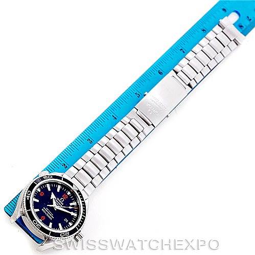 This image shows an overhead view of the Omega Planet Ocean 2201.51.00 Men's Stainless Steel Black Dial 2201.51.00 Men's Stainless Steel Black Dial watch with its metal bracelet next to a blue ruler.