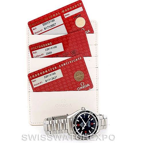 This image shows the Omega Planet Ocean 2201.51.00 Men's Stainless Steel Black Dial 2201.51.00 Men's Stainless Steel Black Dial watch and its warranty cards, photographed from a top-down angle.