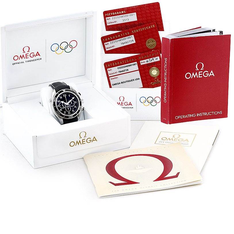 The Omega Planet Ocean 222.32.46.50.01.001 Men
s Stainless Steel Black Dial 222.32.46.50.01.001 Men
s Stainless Steel Black Dial watch is shown from a front angle, along with its box, instruction manual, and warranty cards.