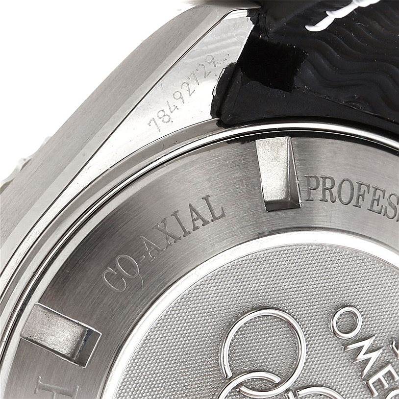 The image shows the angled view of an Omega Planet Ocean 222.32.46.50.01.001 Men
s Stainless Steel Black Dial 222.32.46.50.01.001 Men
s Stainless Steel Black Dial watch, focusing on the case back, engraving, and bezel.