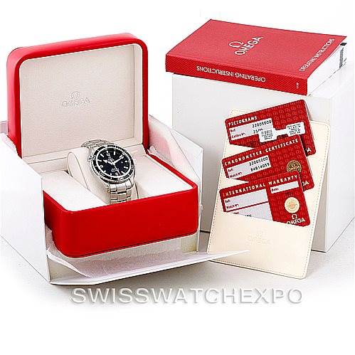 The image shows an Omega Planet Ocean 2200.50.00 Men
s Stainless Steel Black Dial 2200.50.00 Men
s Stainless Steel Black Dial watch in a red box with accompanying warranty cards and a manual placed beside it.