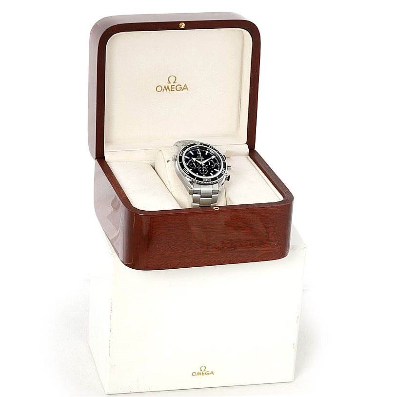 The Omega Planet Ocean 2210.50.00 Men
s Stainless Steel Black Dial 2210.50.00 Men
s Stainless Steel Black Dial watch is presented front angle in a wooden Omega box with a white interior.