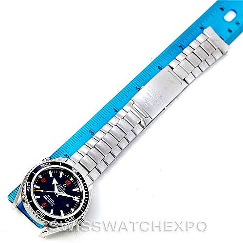 The image shows the Omega Planet Ocean 2200.51.00 Men
s Stainless Steel Black Dial 2200.51.00 Men
s Stainless Steel Black Dial watch laid flat with its bracelet and clasp fully visible next to a ruler for scale.