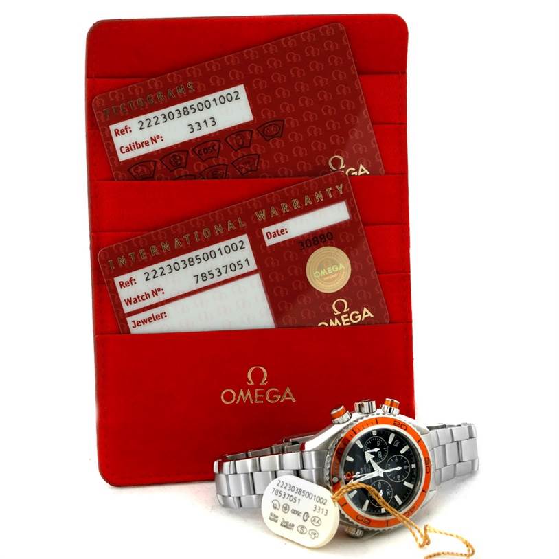 The image shows the Omega Planet Ocean 222.30.38.50.01.002 Stainless Steel Black Dial 222.30.38.50.01.002 Stainless Steel Black Dial watch and its accessories including warranty cards and a red Omega cardholder.