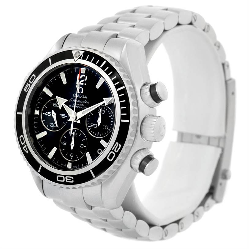 The image shows a side angle view of an Omega Planet Ocean 222.30.38.50.01.001 Stainless Steel Black Dial 222.30.38.50.01.001 Stainless Steel Black Dial watch, highlighting the face, bezel, chronograph buttons, and bracelet.