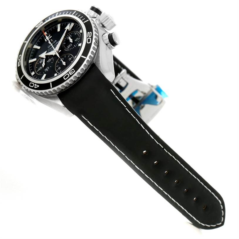 The Planet Ocean model by Omega is shown at an angled view, highlighting its black leather strap, bezel, and chronograph buttons.
