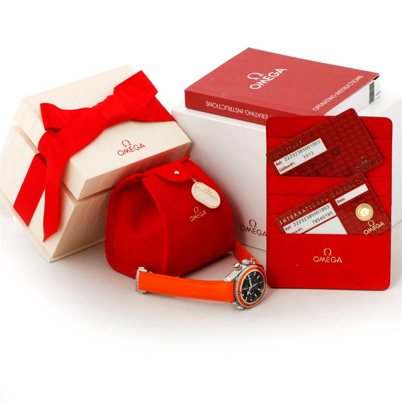 The image shows the Omega Planet Ocean 222.32.38.50.01.003 Stainless Steel Black Dial 222.32.38.50.01.003 Stainless Steel Black Dial watch with an orange strap, packaging, operating instructions, and warranty cards.