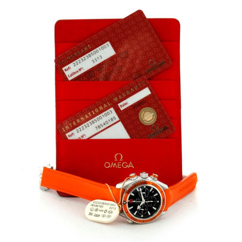 The Omega Planet Ocean 222.32.38.50.01.003 Stainless Steel Black Dial 222.32.38.50.01.003 Stainless Steel Black Dial watch is shown at an angle, along with its orange strap, warranty cards, and an Omega-branded cardholder.