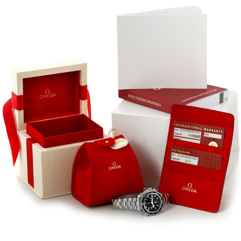 The image shows an Omega Planet Ocean 222.30.38.50.01.003 Men
s Stainless Steel Black Dial 222.30.38.50.01.003 Men
s Stainless Steel Black Dial watch with its packaging, warranty cardholder, booklets, and a red travel pouch.