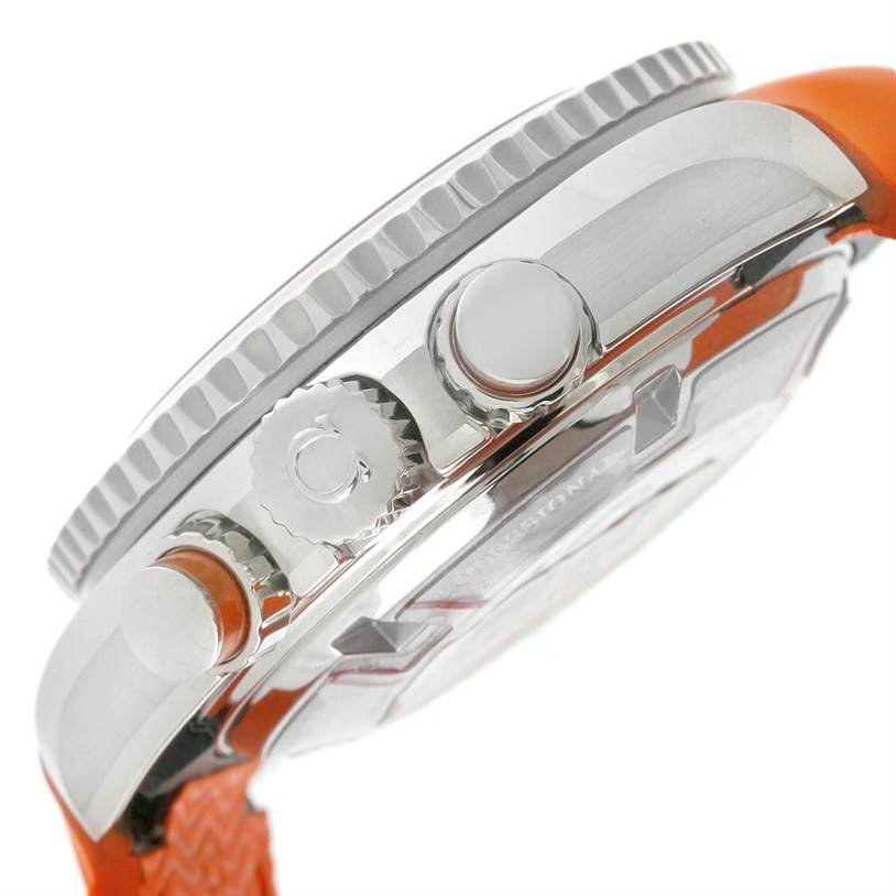 The image shows a side view of the Omega Planet Ocean 222.32.38.50.01.003 Stainless Steel Black Dial 222.32.38.50.01.003 Stainless Steel Black Dial watch, highlighting the crown, pushers, and part of the orange strap.