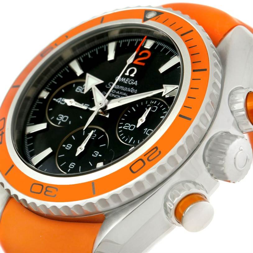 The image shows a close-up, angled view of the Omega Planet Ocean 222.32.38.50.01.003 Stainless Steel Black Dial 222.32.38.50.01.003 Stainless Steel Black Dial watch, highlighting its dial, bezel, and orange strap.