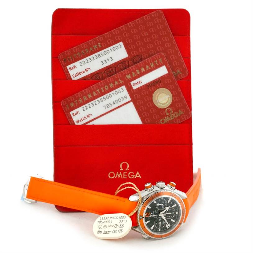 The image shows an Omega Planet Ocean 222.32.38.50.01.003 Stainless Steel Black Dial 222.32.38.50.01.003 Stainless Steel Black Dial watch with an orange strap and warranty cards, photographed from an angled front view.