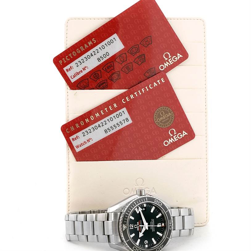 The image shows an Omega Planet Ocean 232.30.42.21.01.003 Men
s Stainless Steel Black Dial 232.30.42.21.01.003 Men
s Stainless Steel Black Dial watch face and bracelet, alongside its Pictograms and Chronometer Certificate cards.