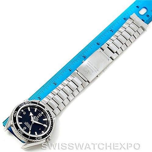 The image shows a top-down view of the Omega Planet Ocean 2200.50.00 Men
s Stainless Steel Black Dial 2200.50.00 Men
s Stainless Steel Black Dial watch, including its face, metal bracelet, and clasp, next to a ruler.