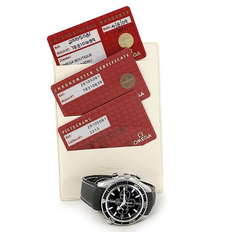 The image shows the Omega Planet Ocean 2910.50.81 Men
s Stainless Steel Black Dial 2910.50.81 Men
s Stainless Steel Black Dial watch with its warranty, chronometer certificate, and pictogram cards.