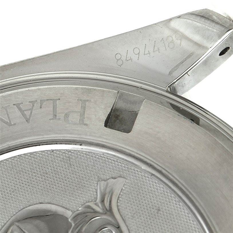 The image shows a close-up of the case back and part of the lug of the Omega Planet Ocean 2200.50.00 Men
s Stainless Steel Black Dial 2200.50.00 Men
s Stainless Steel Black Dial watch, highlighting the branding and serial number.