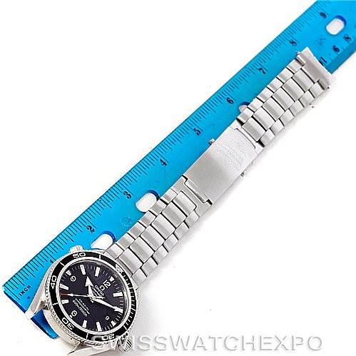 The image shows an Omega Planet Ocean 2201.50.00 Men
s Stainless Steel Black Dial 2201.50.00 Men
s Stainless Steel Black Dial watch laid flat next to a blue ruler, displaying the face, bezel, and stainless steel bracelet.