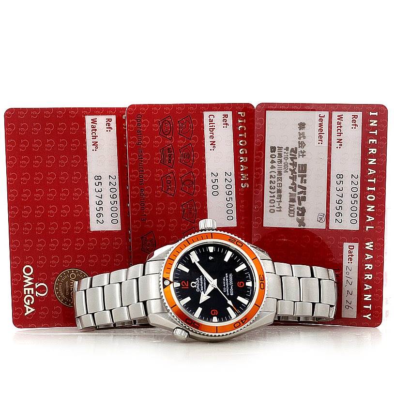 The image shows an Omega Planet Ocean 2209.50.00 Men
s Stainless Steel Black Dial 2209.50.00 Men
s Stainless Steel Black Dial watch from a front angle, along with its warranty and identification cards.