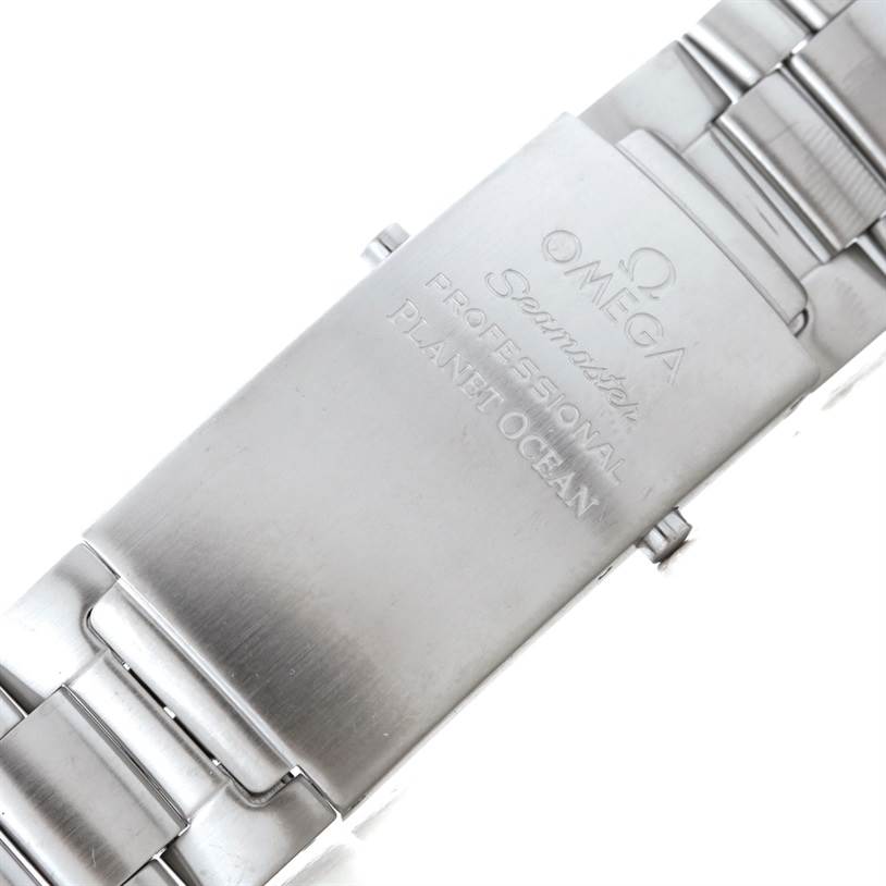The image shows a close-up of the clasp on the Omega Seamaster Planet Ocean watch bracelet.