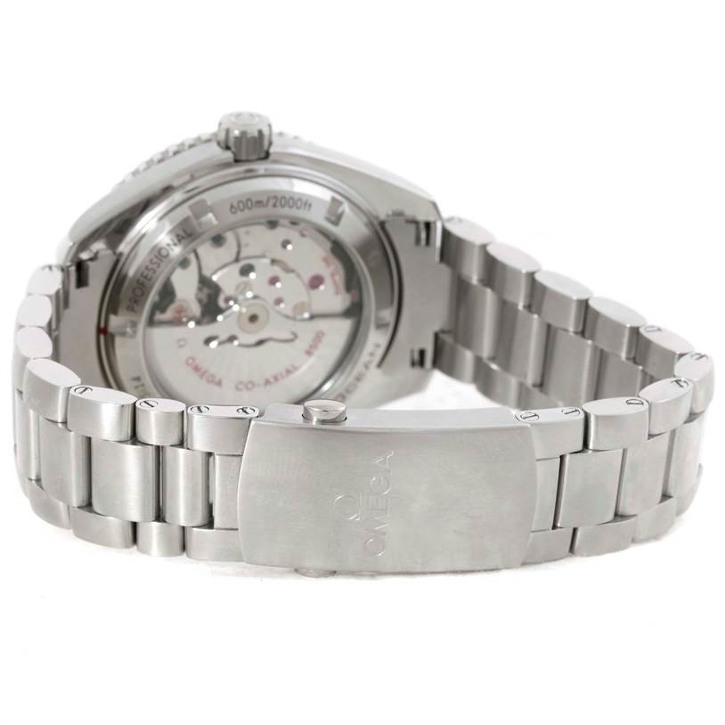 The image shows the back view of the Omega Planet Ocean 232.30.42.21.01.001 Men
s Stainless Steel Black Dial 232.30.42.21.01.001 Men
s Stainless Steel Black Dial watch, highlighting its see-through case back and metal bracelet.