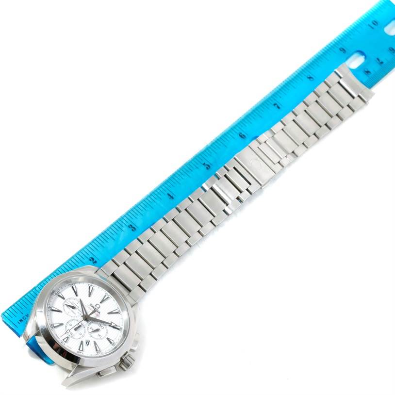 The image shows an Omega Aqua Terra 231.10.44.50.04.001 Men's Stainless Steel White Dial 231.10.44.50.04.001 Men's Stainless Steel White Dial watch laid flat, with its dial and metal bracelet fully visible alongside a blue ruler.