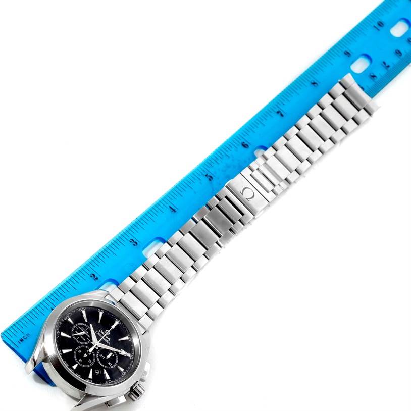 The image shows an Omega Aqua Terra 231.10.44.50.01.001 Men
s Stainless Steel Black Dial 231.10.44.50.01.001 Men
s Stainless Steel Black Dial watch and bracelet band laid flat next to a ruler, viewed from above.