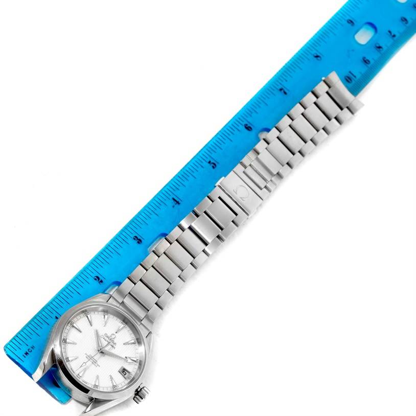 The image shows the Omega Aqua Terra 231.10.39.21.02.001 Men's Stainless Steel Silver Dial 231.10.39.21.02.001 Men's Stainless Steel Silver Dial watch from a top-down angle, alongside a ruler measuring its metal bracelet.