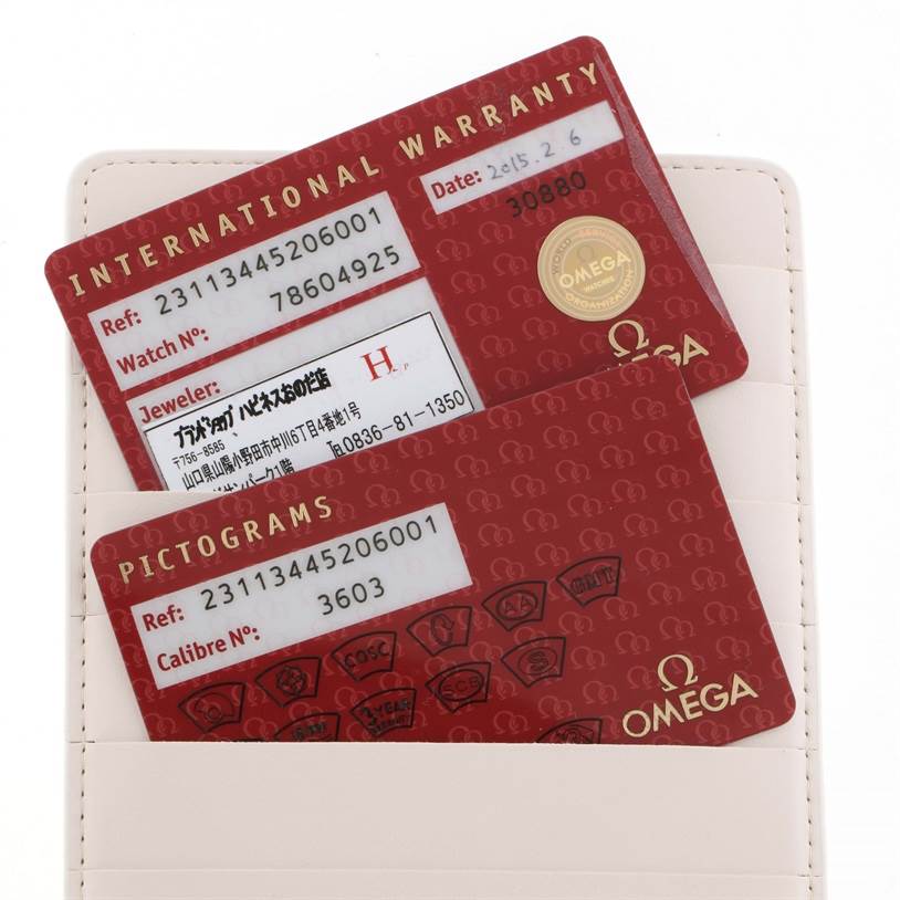 The image shows warranty and pictograms cards for the Omega Aqua Terra 231.13.44.52.06.001 Men
s Stainless Steel Grey Dial 231.13.44.52.06.001 Men
s Stainless Steel Grey Dial model, partially placed in a cardholder.