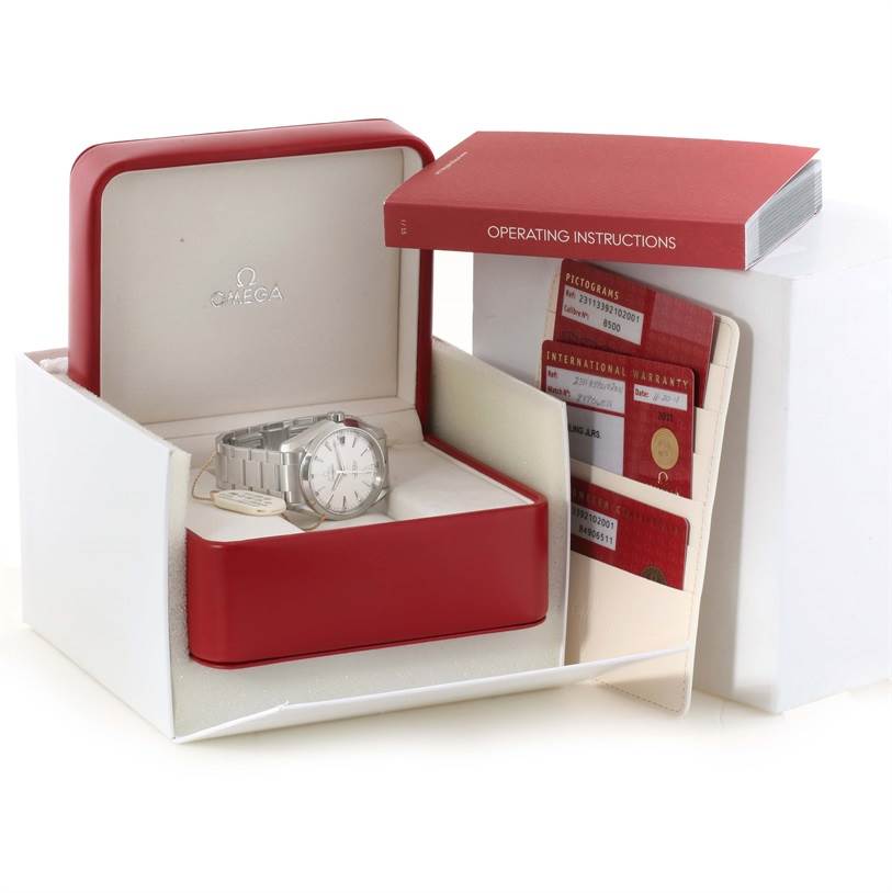 The image shows an Omega Aqua Terra 231.13.39.21.02.001 Men
s Stainless Steel Silver Dial 231.13.39.21.02.001 Men
s Stainless Steel Silver Dial watch in its box, accompanied by operating instructions, warranty cards, and an exterior case.