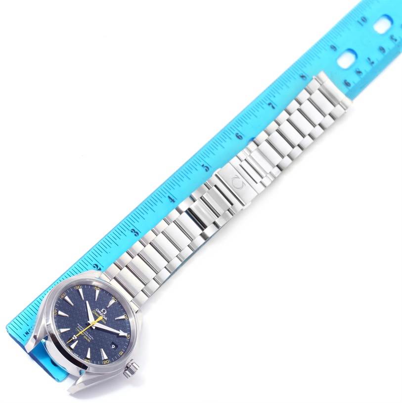 The image shows an Omega Aqua Terra 231.10.42.21.03.004 Men
s Stainless Steel Blue Dial 231.10.42.21.03.004 Men
s Stainless Steel Blue Dial watch laid down next to a ruler, displaying its face, bracelet, and clasp.