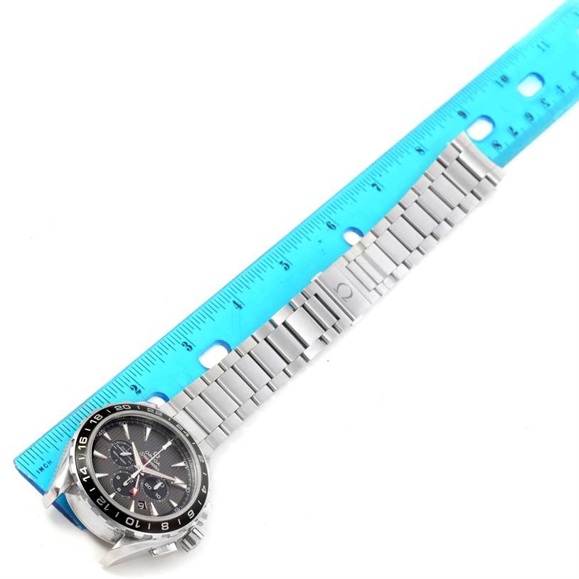 The image shows an Omega Aqua Terra 231.10.44.52.06.001 Men
s Stainless Steel Grey Dial 231.10.44.52.06.001 Men
s Stainless Steel Grey Dial watch with its dial and metal bracelet laid next to a blue ruler for scale.