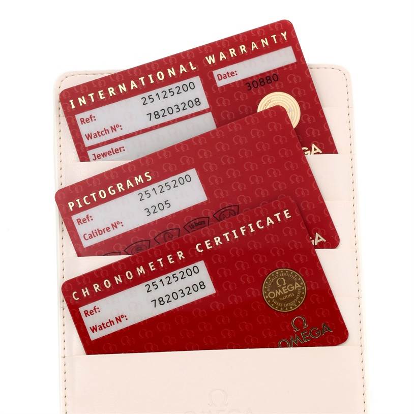 The image shows the warranty cards and certificates for an Omega Aqua Terra 2512.52.00 Men
s Stainless Steel Black Dial 2512.52.00 Men
s Stainless Steel Black Dial watch.