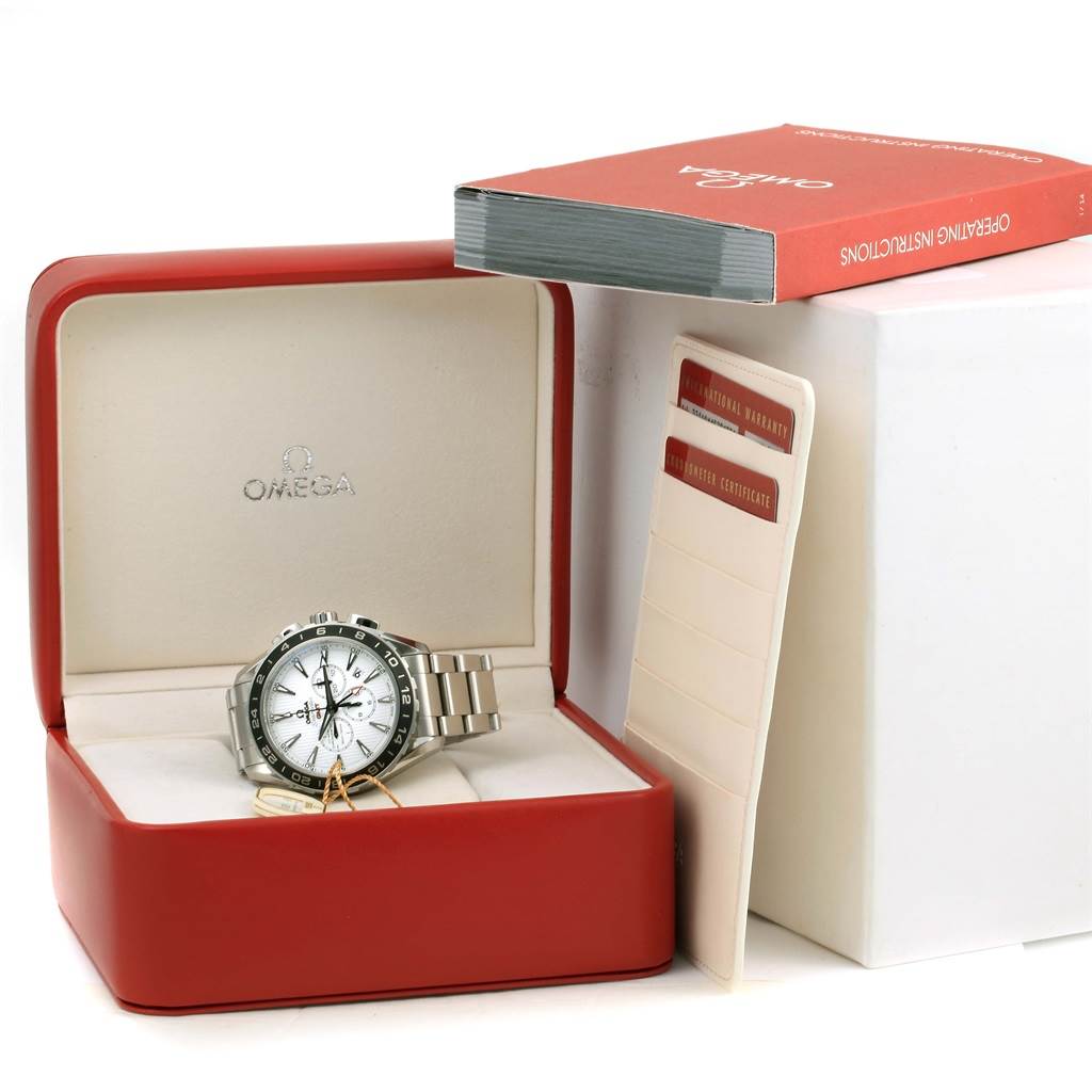 The Omega Aqua Terra 231.10.44.52.04.001 Men
s Stainless Steel White Dial 231.10.44.52.04.001 Men
s Stainless Steel White Dial watch is shown in a red display box, along with an instruction manual and warranty cards.