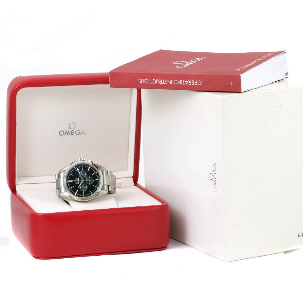 The image shows an Omega Aqua Terra 2512.50.00 Men's Stainless Steel Black Dial 2512.50.00 Men's Stainless Steel Black Dial wristwatch inside a red box with an instruction manual partially visible next to it.