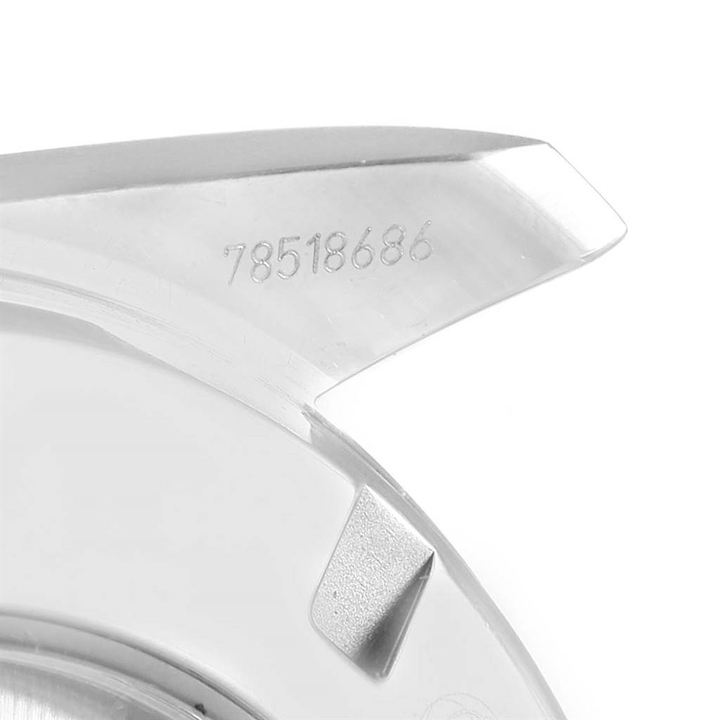 The image shows a close-up of the lug and part of the case back of an Omega Aqua Terra 231.10.44.50.04.001 Men's Stainless Steel White Dial 231.10.44.50.04.001 Men's Stainless Steel White Dial watch, with a visible serial number engraved.